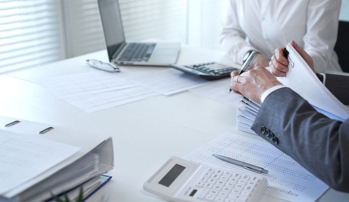 Accountants reviewing financial records and tax paperwork