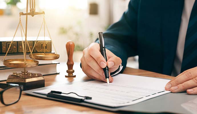 Lawyer signing legal documents