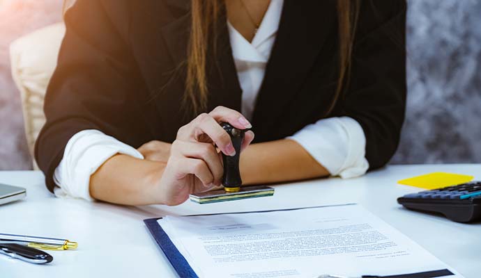 Notary stamping an official document