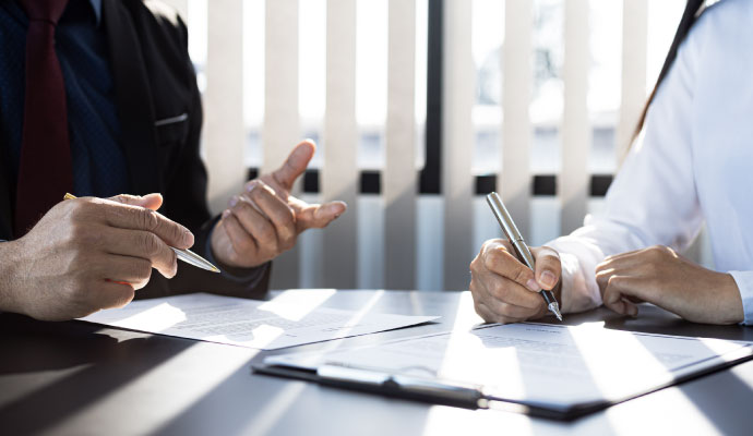 Tax preparer explaining return documents to a client