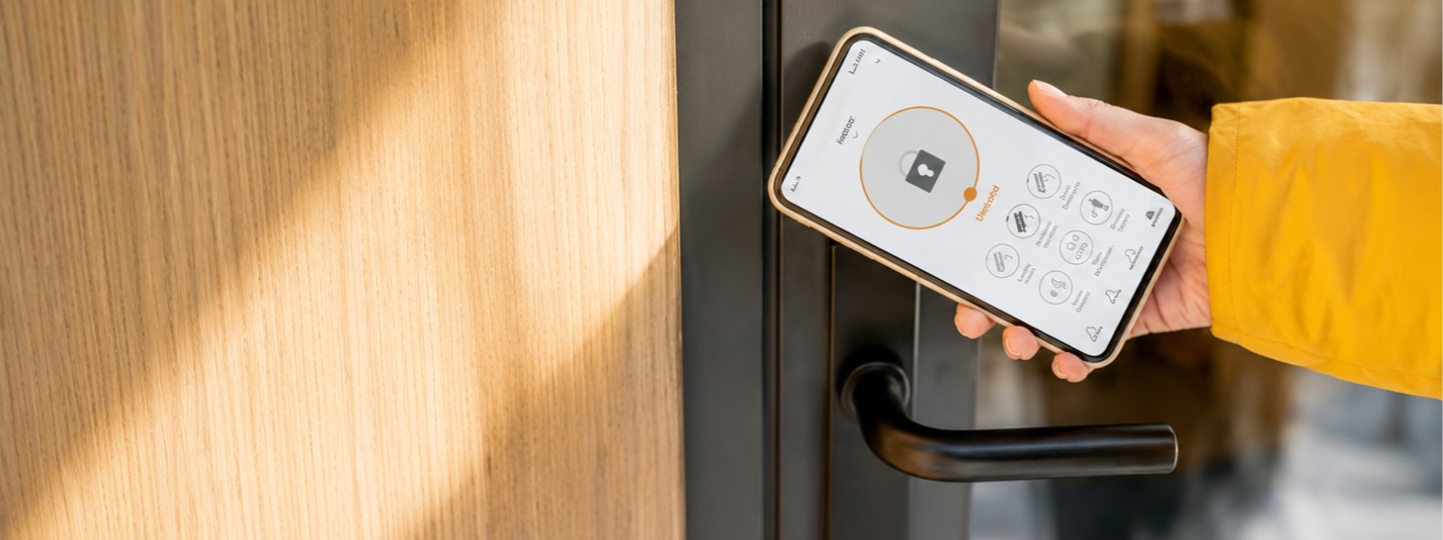 A person unlocking door using smartphone
