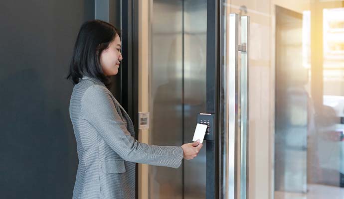 A person using key card reader for access