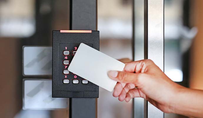 A person using key card reader for access