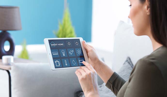 A woman using home control application  interface on a tablet