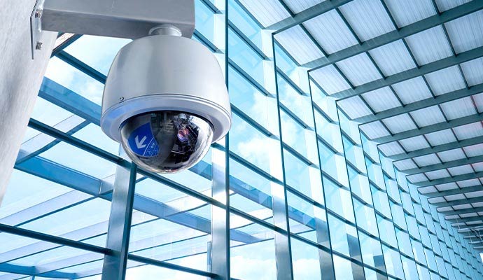 Commercial dome security camera mounted in glass building