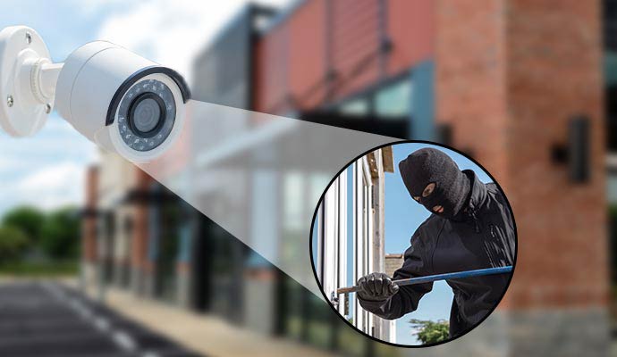 Commercial security camera detecting burglar with crowbar