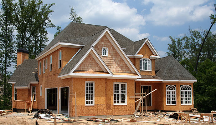 Custom two-story home under construction with OSB sheathing.