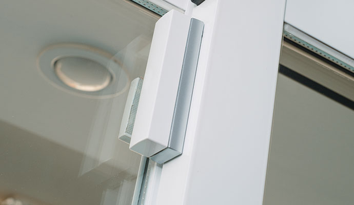 White magnetic door and window contact sensor on a frame.