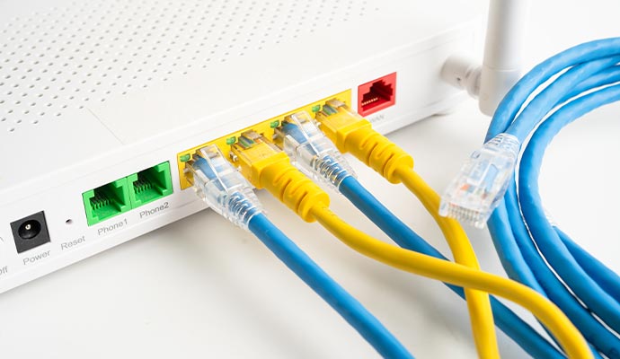 Ethernet cables plugged into a wifi router