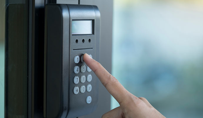 Finger entering a code on an electronic access keypad