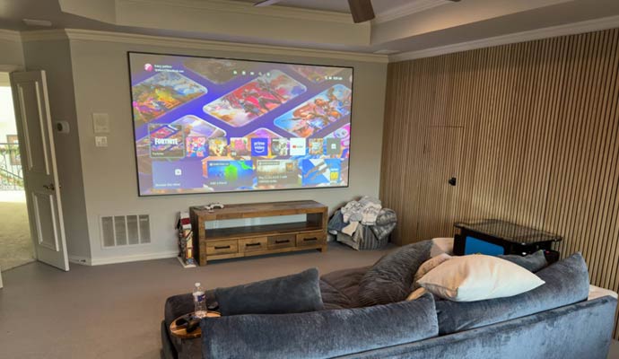 Large projector screen displaying media in home theater
