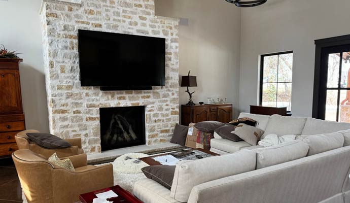 Living room with TV and soundbar mounted above fireplace