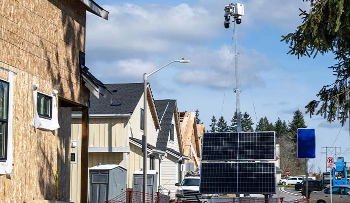 Mobile solar-powered surveillance trailer unit at construction site