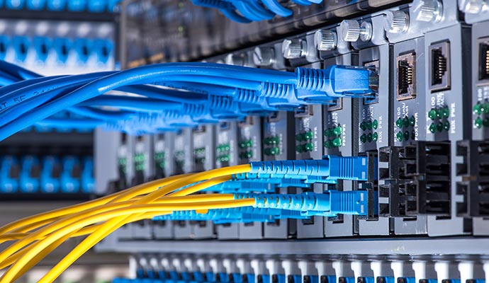 Network switch with connected fiber optic cables and ports