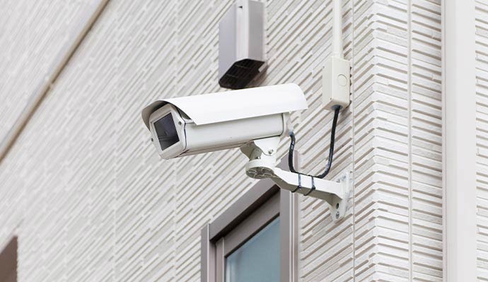 Outdoor bullet security camera mounted on commercial building