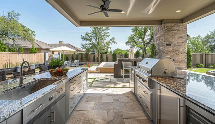 Outdoor kitchen with grill and granite countertops