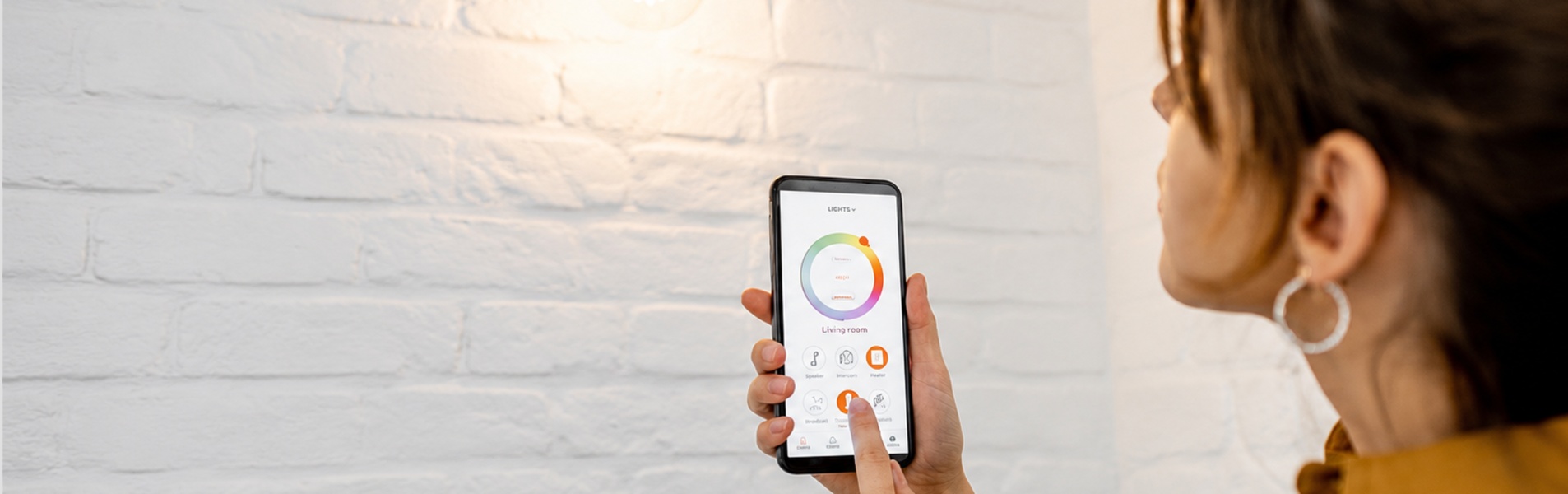 Person using smartphone to control light