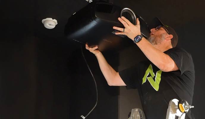 Technician mounting ceiling projector