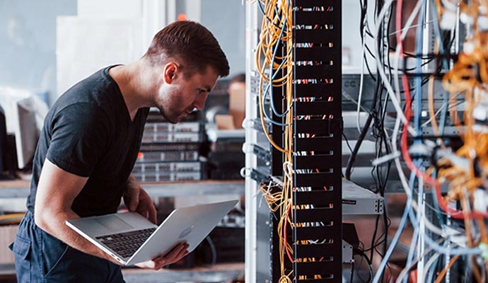 Technician performing a cabling site survey at a server room