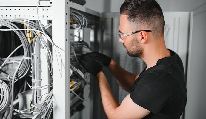 Technician setting up and installing network equipment
