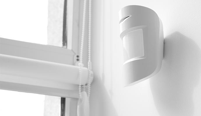 Wireless motion detector mounted near window