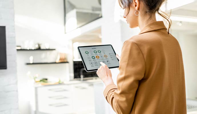 Woman controlling smart home system using tablet
