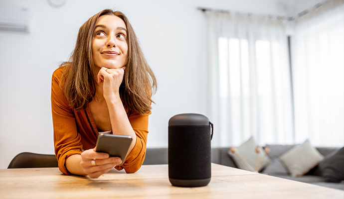 A woman standing beside a smart voice control system