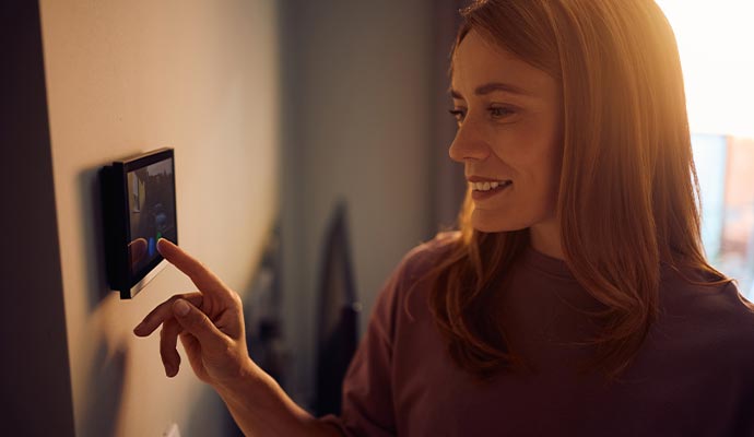 Woman using paging system for smart home control